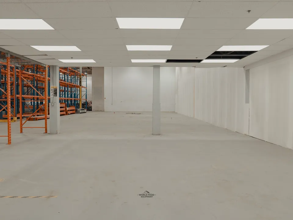 The Toronto warehouse Atlas Foods came to WFE with on day one, drop-ceiling office area on the left, orange pallet racking pre-positioned on the right, open floor and no cold storage in place.