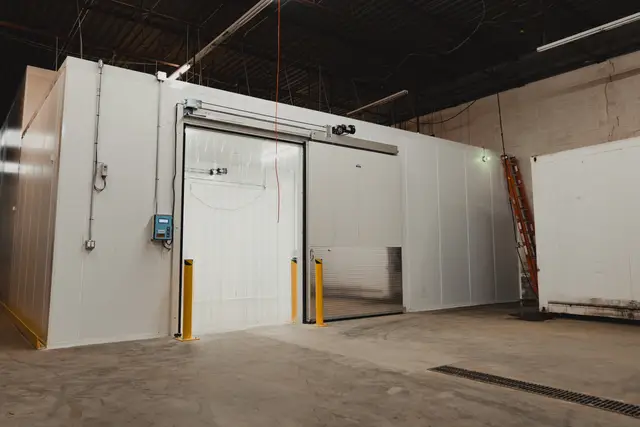 Walk-in cooler with sliding door in a warehouse
