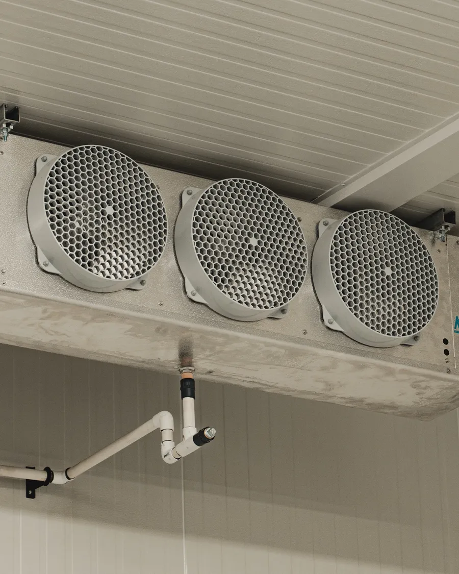 KeepRite three-fan evaporator unit mounted on the white ceiling of a finished walk-in cooler, SKOR Crestlawn install, Ontario, World Food Equipment