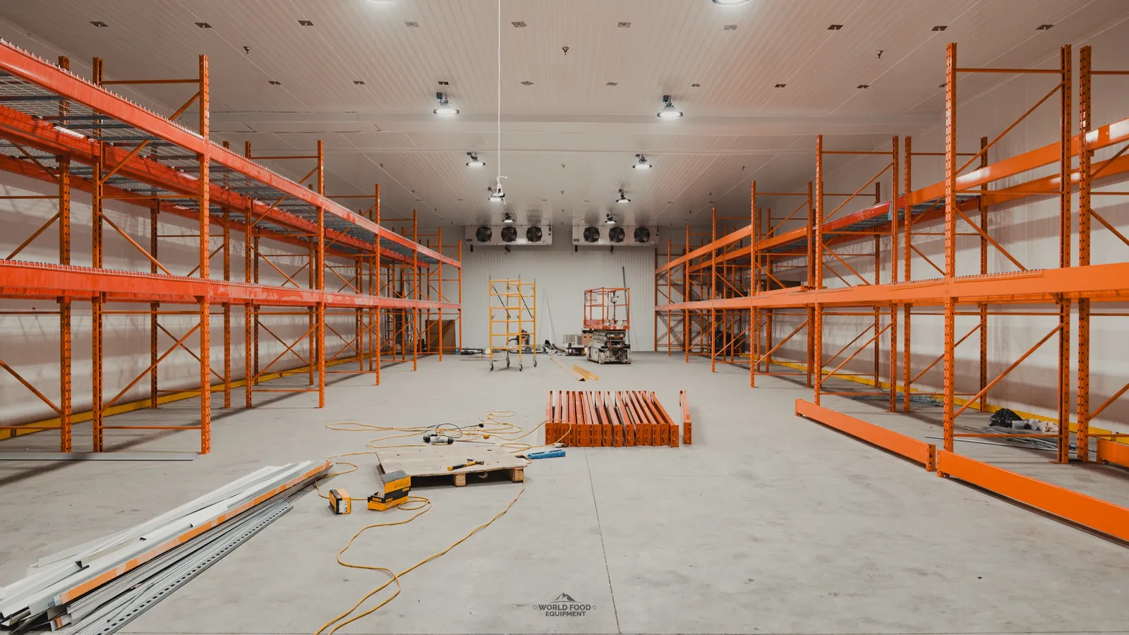 Walk-in freezer during construction, panels staged and racking partially installed, Ontario meat-processing facility, World Food Equipment