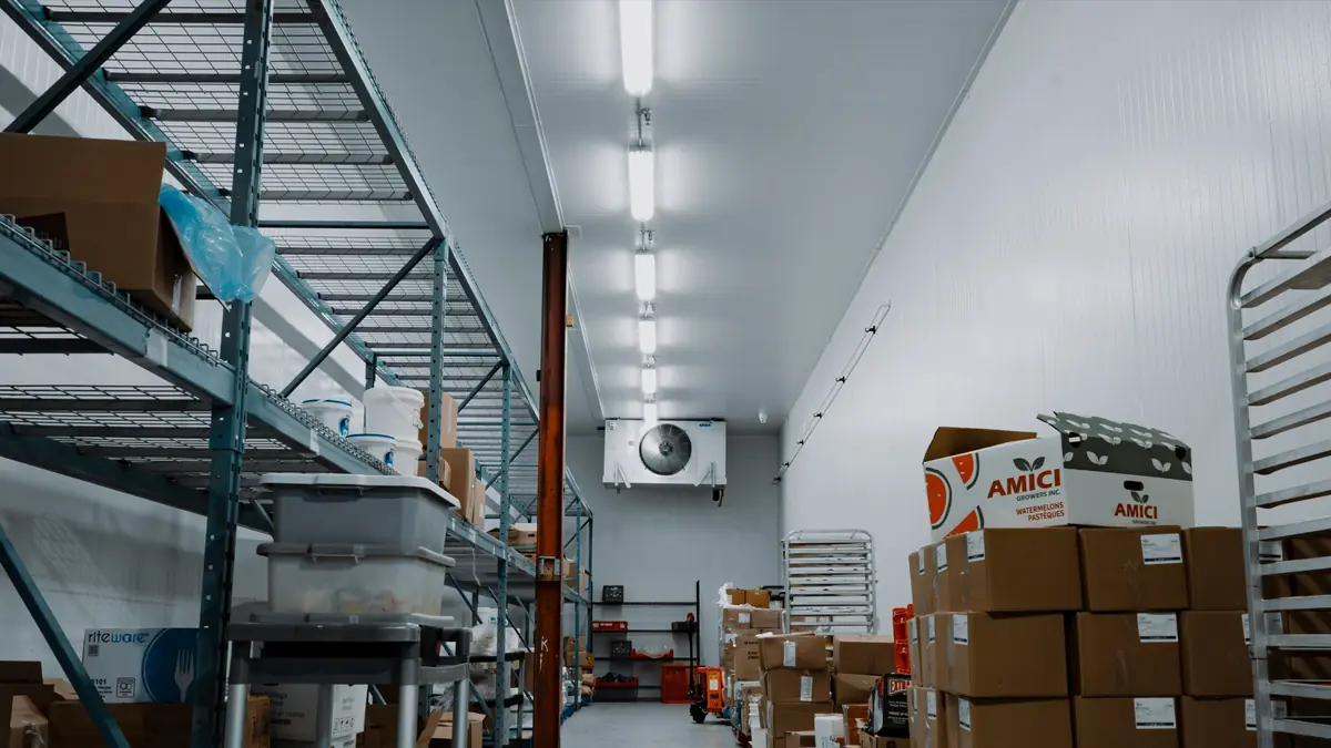 Stocked walk-in cooler aisle in Toronto with clear space between the product and the ceiling evaporator at the far wall